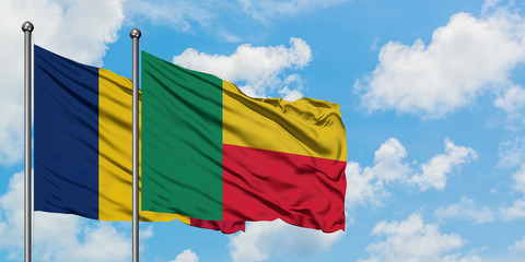 Chad and Benin flag waving in the wind against white cloudy blue sky together. Diplomacy concept, international relations.