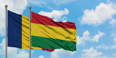 Chad and Bolivia flag waving in the wind against white cloudy blue sky together. Diplomacy concept, international relations.