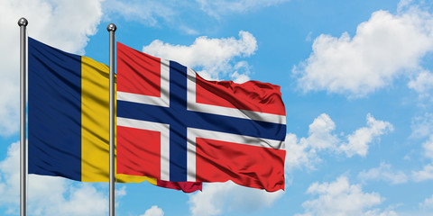 Chad and Bouvet Islands flag waving in the wind against white cloudy blue sky together. Diplomacy concept, international relations.