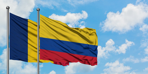 Chad and Colombia flag waving in the wind against white cloudy blue sky together. Diplomacy concept, international relations.