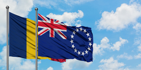 Chad and Cook Islands flag waving in the wind against white cloudy blue sky together. Diplomacy concept, international relations.