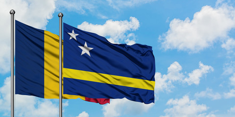 Chad and Curacao flag waving in the wind against white cloudy blue sky together. Diplomacy concept, international relations.