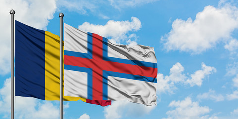 Chad and Faroe Islands flag waving in the wind against white cloudy blue sky together. Diplomacy concept, international relations.