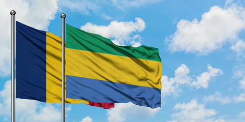 Chad and Gabon flag waving in the wind against white cloudy blue sky together. Diplomacy concept,...
