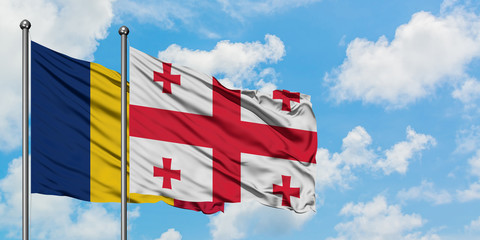 Chad and Georgia flag waving in the wind against white cloudy blue sky together. Diplomacy concept, international relations.