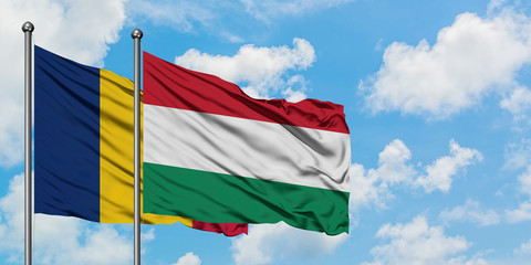 Chad and Hungary flag waving in the wind against white cloudy blue sky together. Diplomacy concept, international relations.