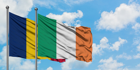 Chad and Ireland flag waving in the wind against white cloudy blue sky together. Diplomacy concept, international relations.