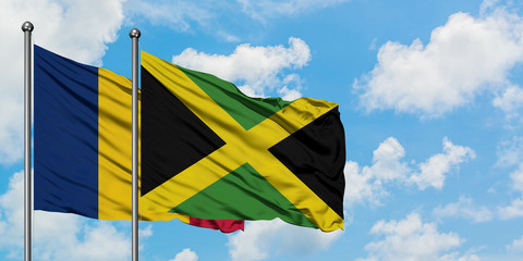 Chad and Jamaica flag waving in the wind against white cloudy blue sky together. Diplomacy concept, international relations.