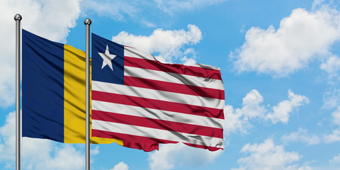 Chad and Liberia flag waving in the wind against white cloudy blue sky together. Diplomacy concept, international relations.
