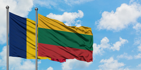 Chad and Lithuania flag waving in the wind against white cloudy blue sky together. Diplomacy...