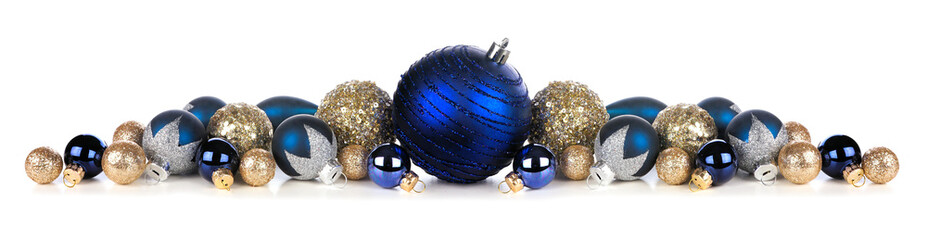 Christmas border of deep blue and gold ornaments. Side view isolated on a white background.