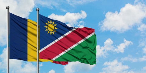 Chad and Namibia flag waving in the wind against white cloudy blue sky together. Diplomacy concept, international relations.