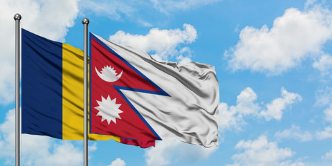 Chad and Nepal flag waving in the wind against white cloudy blue sky together. Diplomacy concept, international relations.