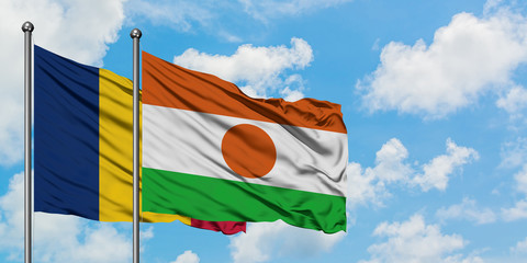 Chad and Niger flag waving in the wind against white cloudy blue sky together. Diplomacy concept,...