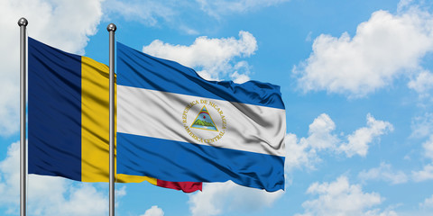 Chad and Nicaragua flag waving in the wind against white cloudy blue sky together. Diplomacy concept, international relations.