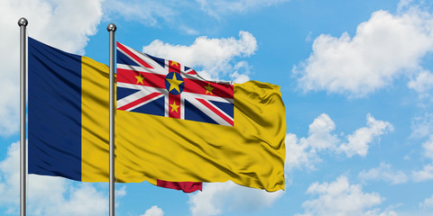 Chad and Niue flag waving in the wind against white cloudy blue sky together. Diplomacy concept, international relations.