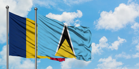 Chad and Saint Lucia flag waving in the wind against white cloudy blue sky together. Diplomacy concept, international relations.