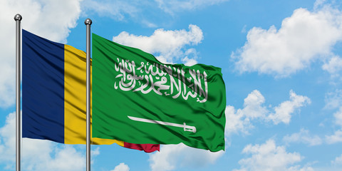 Chad and Saudi Arabia flag waving in the wind against white cloudy blue sky together. Diplomacy concept, international relations.