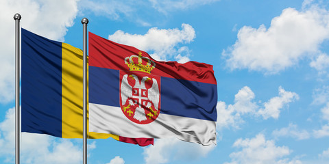 Chad and Serbia flag waving in the wind against white cloudy blue sky together. Diplomacy concept, international relations.