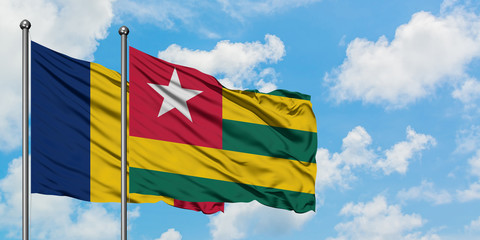 Chad and Togo flag waving in the wind against white cloudy blue sky together. Diplomacy concept, international relations.