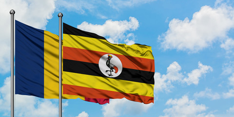 Chad and Uganda flag waving in the wind against white cloudy blue sky together. Diplomacy concept, international relations.