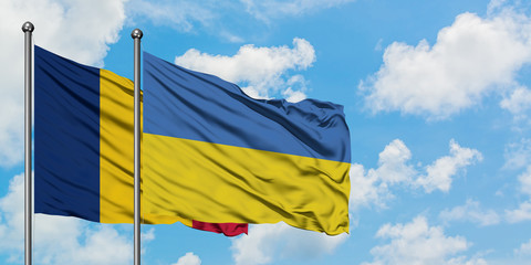 Chad and Ukraine flag waving in the wind against white cloudy blue sky together. Diplomacy concept, international relations.