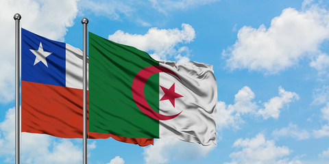 Chile and Algeria flag waving in the wind against white cloudy blue sky together. Diplomacy concept, international relations.
