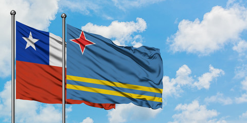 Chile and Aruba flag waving in the wind against white cloudy blue sky together. Diplomacy concept, international relations.