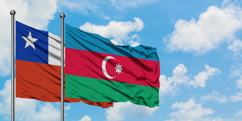 Chile and Azerbaijan flag waving in the wind against white cloudy blue sky together. Diplomacy concept, international relations.