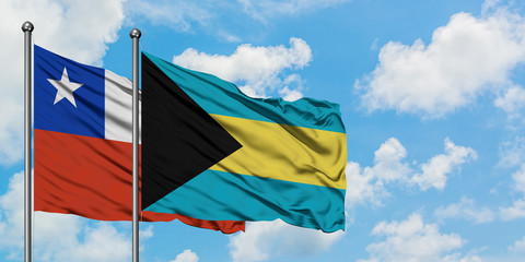 Chile and Bahamas flag waving in the wind against white cloudy blue sky together. Diplomacy concept, international relations.