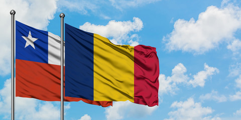 Chile and Chad flag waving in the wind against white cloudy blue sky together. Diplomacy concept, international relations.