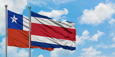 Chile and Costa Rica flag waving in the wind against white cloudy blue sky together. Diplomacy concept, international relations.