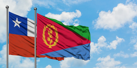 Chile and Eritrea flag waving in the wind against white cloudy blue sky together. Diplomacy concept, international relations.