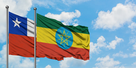 Chile and Ethiopia flag waving in the wind against white cloudy blue sky together. Diplomacy concept, international relations.