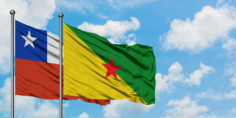 Chile and French Guiana flag waving in the wind against white cloudy blue sky together. Diplomacy concept, international relations.