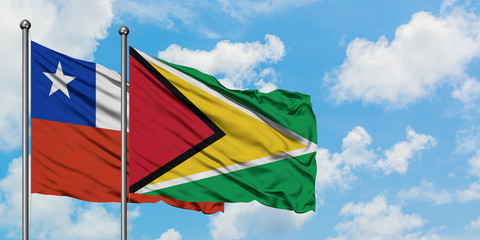 Chile and Guyana flag waving in the wind against white cloudy blue sky together. Diplomacy concept, international relations.