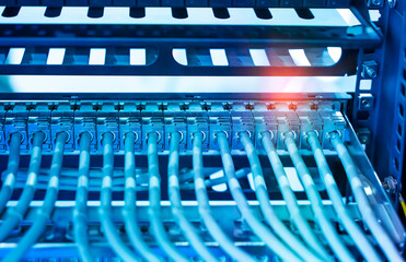 Fototapeta premium Network cable in switch and firewall in cloud computing data center server rack