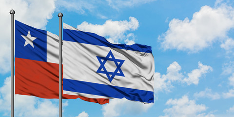 Chile and Israel flag waving in the wind against white cloudy blue sky together. Diplomacy concept, international relations.