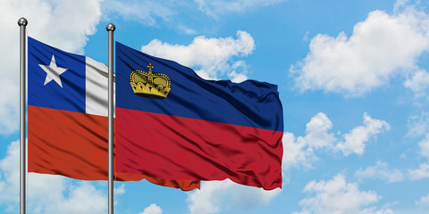 Chile and Liechtenstein flag waving in the wind against white cloudy blue sky together. Diplomacy concept, international relations.