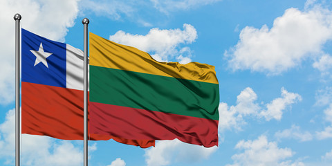 Chile and Lithuania flag waving in the wind against white cloudy blue sky together. Diplomacy concept, international relations.