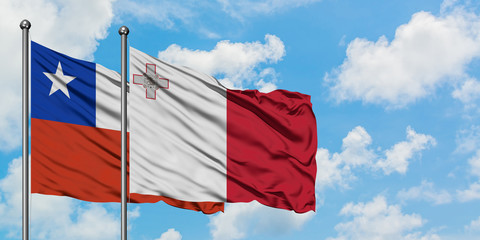 Chile and Malta flag waving in the wind against white cloudy blue sky together. Diplomacy concept, international relations.