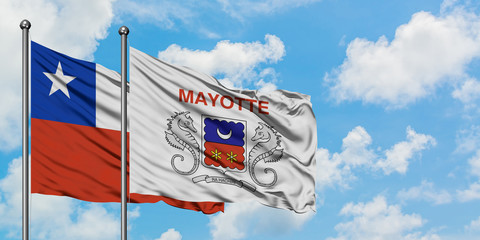 Chile and Mayotte flag waving in the wind against white cloudy blue sky together. Diplomacy concept, international relations.