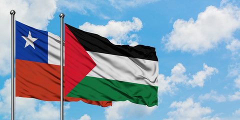 Chile and Palestine flag waving in the wind against white cloudy blue sky together. Diplomacy concept, international relations.