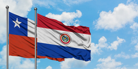 Chile and Paraguay flag waving in the wind against white cloudy blue sky together. Diplomacy concept, international relations.