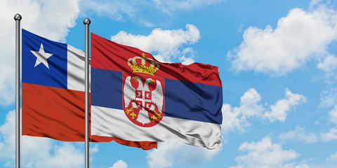 Chile and Serbia flag waving in the wind against white cloudy blue sky together. Diplomacy concept, international relations.