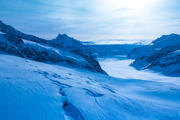 Fototapeta na wymiar Wonderful Winter Landscape. Splendid Alpine scenery: Snowy Mountains at Grindelwald, Switzerland. Snow-covered mountains. Winter travel concept.