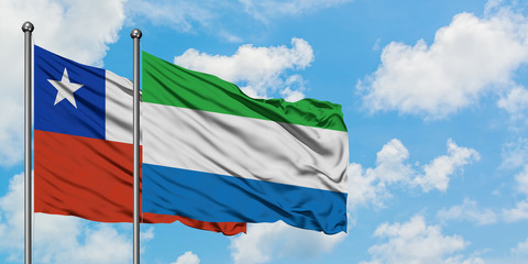 Chile and Sierra Leone flag waving in the wind against white cloudy blue sky together. Diplomacy concept, international relations.