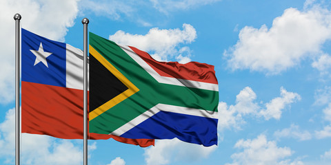 Chile and South Africa flag waving in the wind against white cloudy blue sky together. Diplomacy concept, international relations.