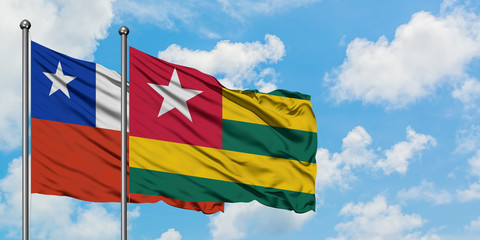Chile and Togo flag waving in the wind against white cloudy blue sky together. Diplomacy concept, international relations.