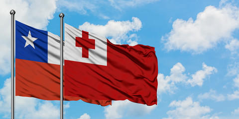 Chile and Tonga flag waving in the wind against white cloudy blue sky together. Diplomacy concept, international relations.
